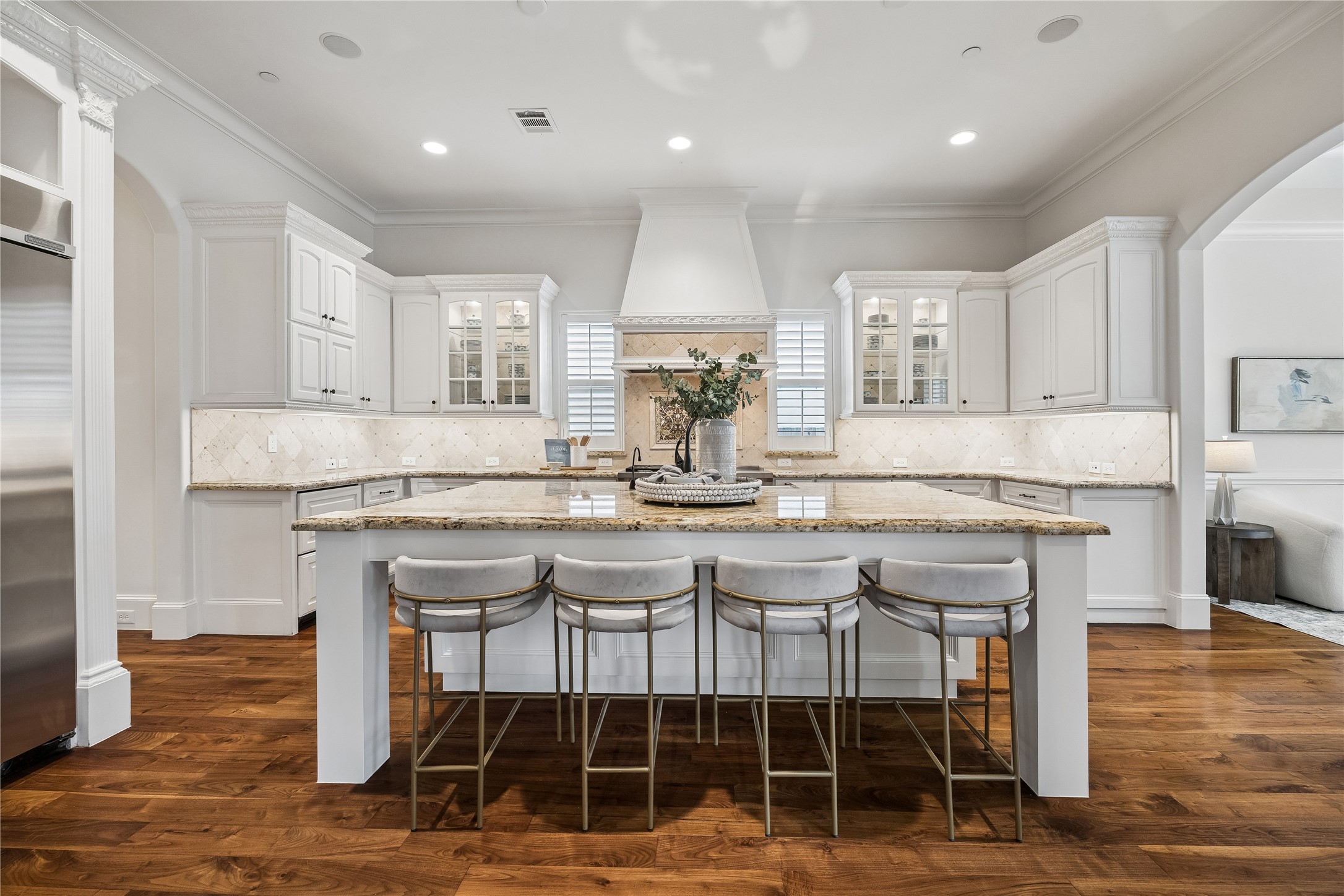 4511 Merrie Lane Bellaire, TX 77401 - Photo 6 of 49 a kitchen with granite countertop a table chairs stove and cabinets