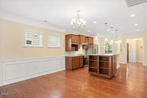 a large white kitchen with a large window