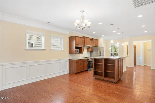 a large white kitchen with a large window