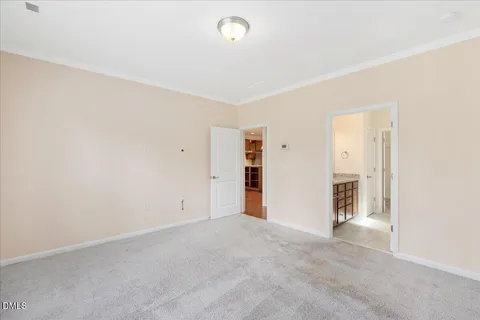 an empty room with closet and windows
