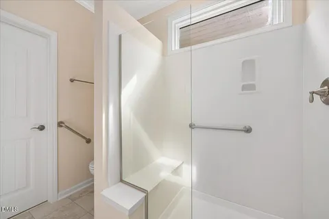 a bathroom with a shower and a toilet
