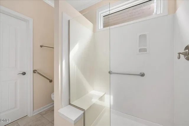 a bathroom with a shower and a toilet