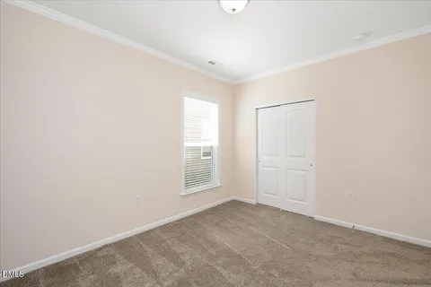 an empty room with windows and closet