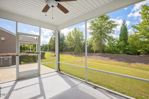 a view of an empty room with a floor to ceiling window and an outdoor view