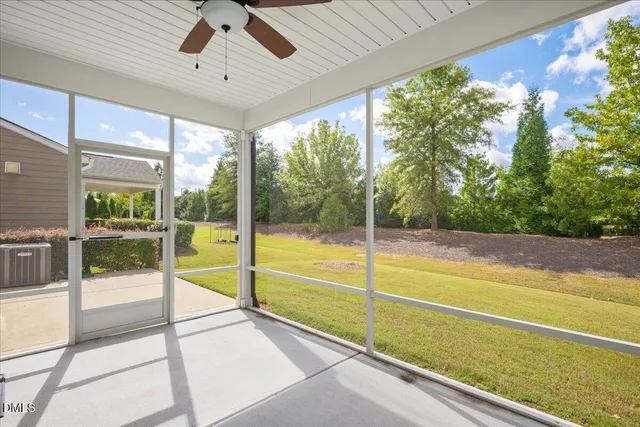 a view of an empty room with a floor to ceiling window and an outdoor view