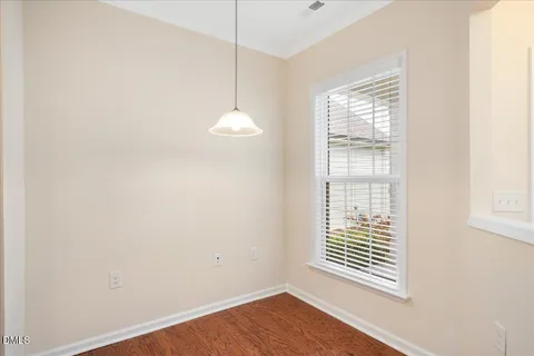 a view of a room with wooden floor and windows