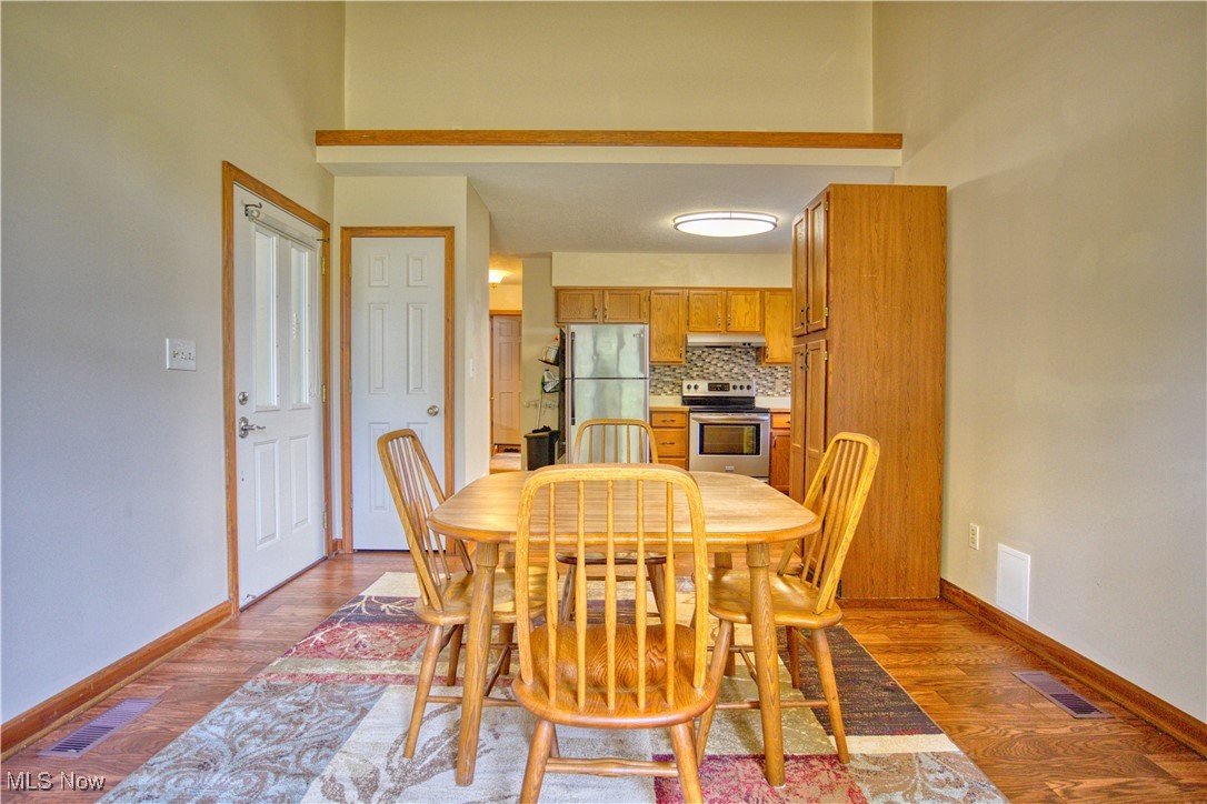 7017 Kirk Road Canfield, OH 44406 - Photo 29 of 35 Dining space with dark wood-style floors and baseboards