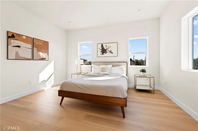 a bedroom with a bed and a view of kitchen