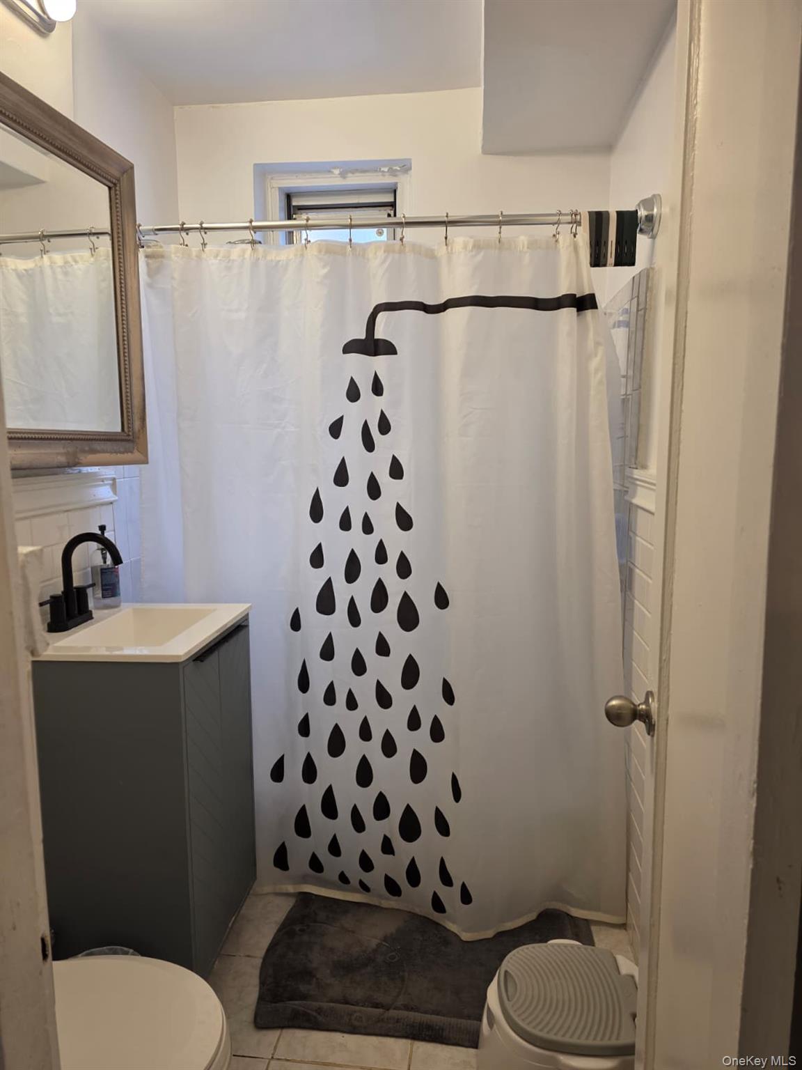 765 Bronx River Road, Unit 3F Bronxville, NY 10708 - Photo 17 of 28 Bathroom with a white tiled shower surround and a window