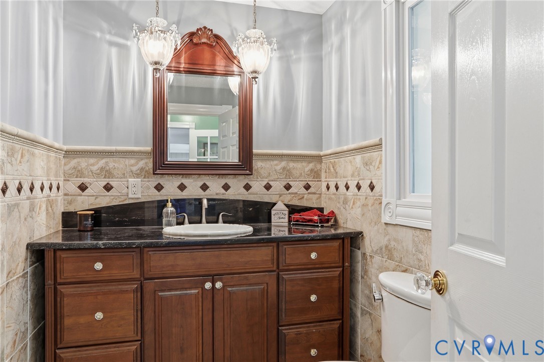 13300 West Patrick Henry Road Doswell, VA 23047 - Photo 16 of 69 Half bathroom featuring a dark wood vanity with a