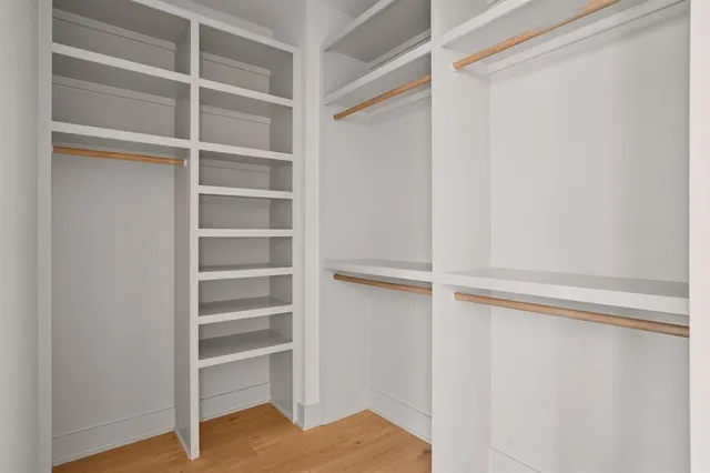 a view of walk in closet with empty racks