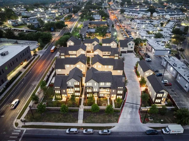 an aerial view of residential houses with outdoor space