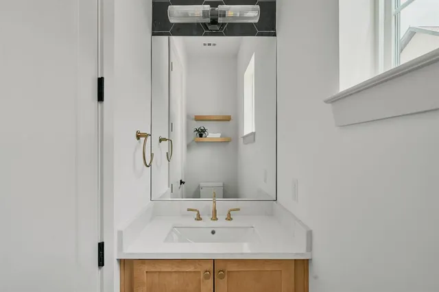 a bathroom with a sink and a mirror