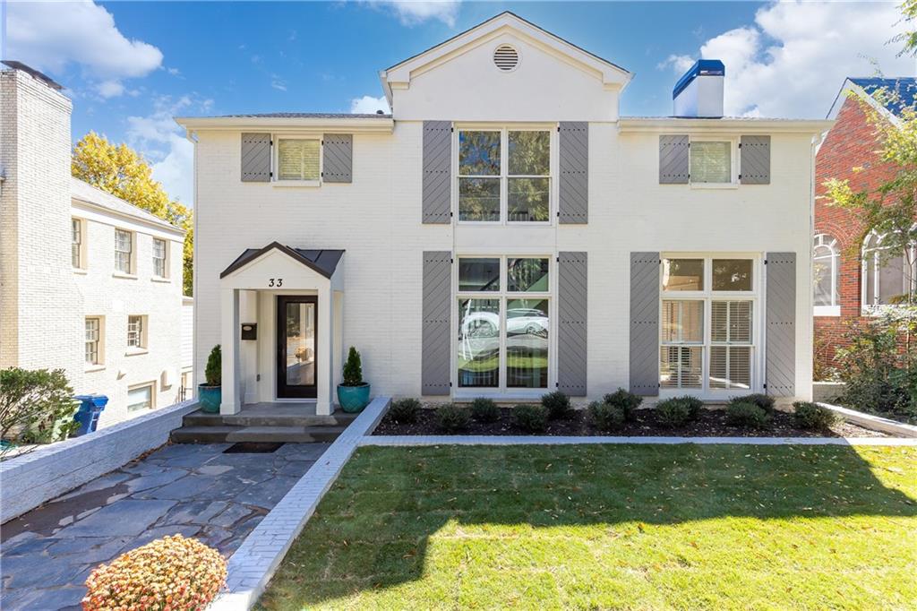 a front view of a house with garden