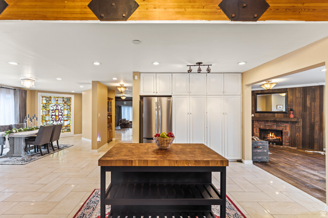 460 Omni Point Road Central Valley, UT 84754 - Photo 28 of 101 Butcher block island with open shelving and white paneled cabinetry