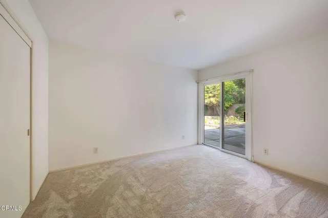 a view of an empty room and a window