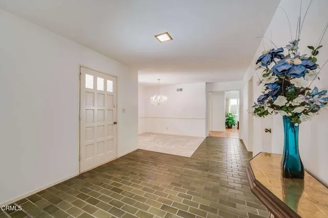 a view of entryway with window and wooden floor