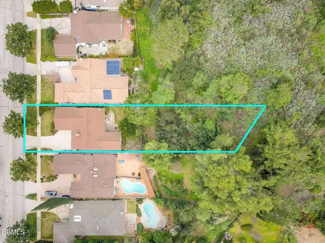 an aerial view of residential houses with outdoor space and street view