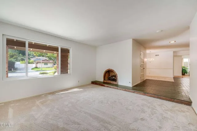 a view of a livingroom with a window and wooden floor