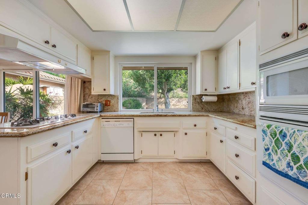 1906 Vía Del Rey South Pasadena, CA 91030 - Photo 5 of 22 a large white kitchen with granite countertop a window