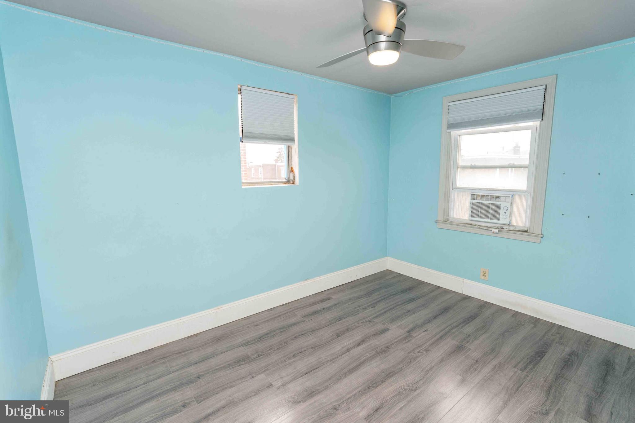 1130 Fanshawe Street Philadelphia, PA 19111 - Photo 16 of 32 an empty room with wooden floor chandelier fan and windows