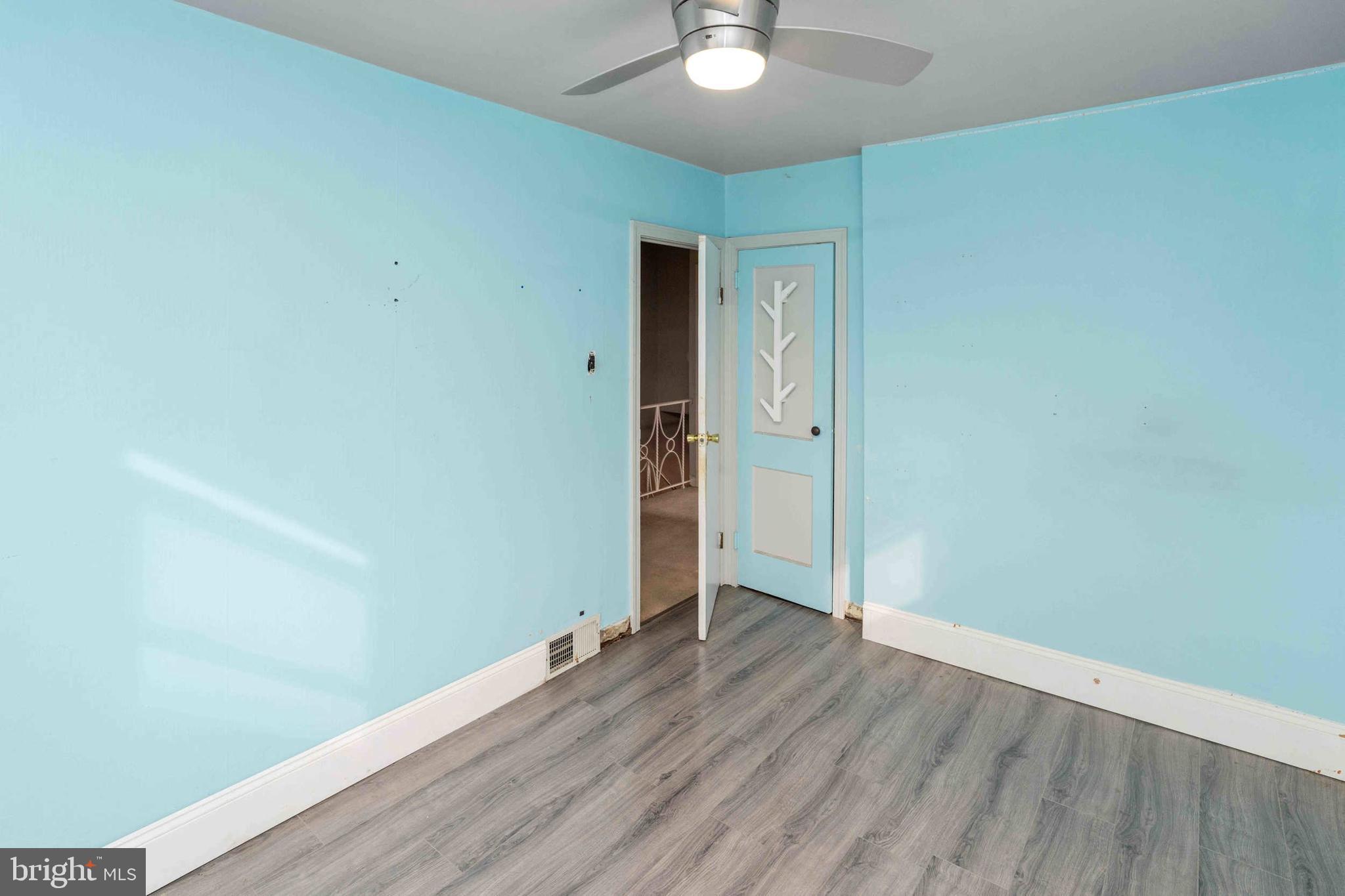 1130 Fanshawe Street Philadelphia, PA 19111 - Photo 17 of 32 an empty room with wooden floor and chandelier fan
