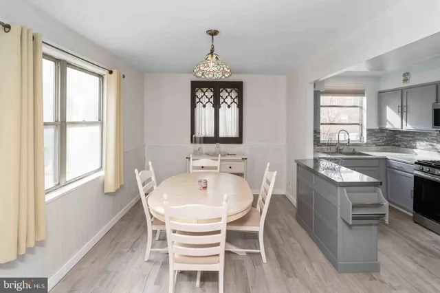 a view of a dining room with furniture window and wooden floor