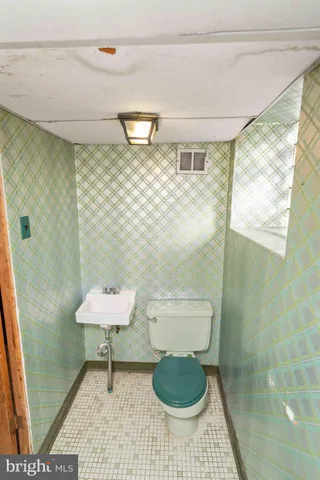 a view of a house with a yard and lawn chairs