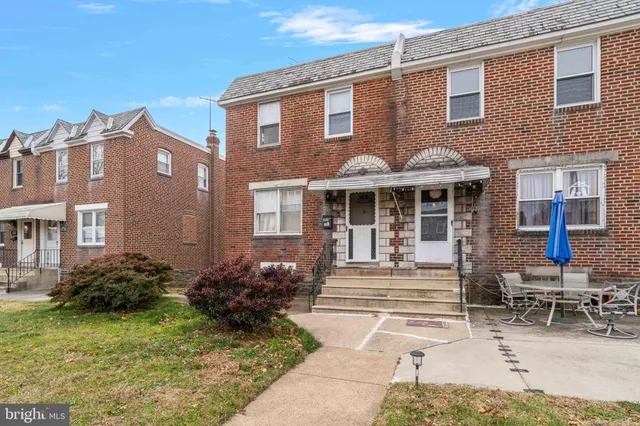 a brick building with a tree in front
