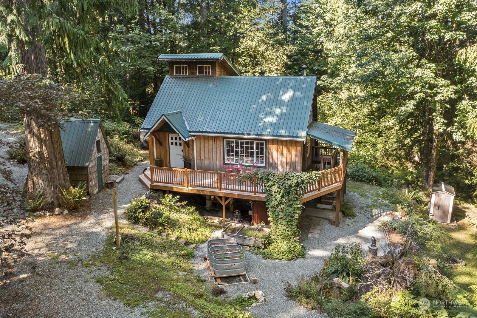 52703 Deep Woods Road Index, WA 98256 - Photo 1 of 29 an aerial view of a house with a yard table and chairs