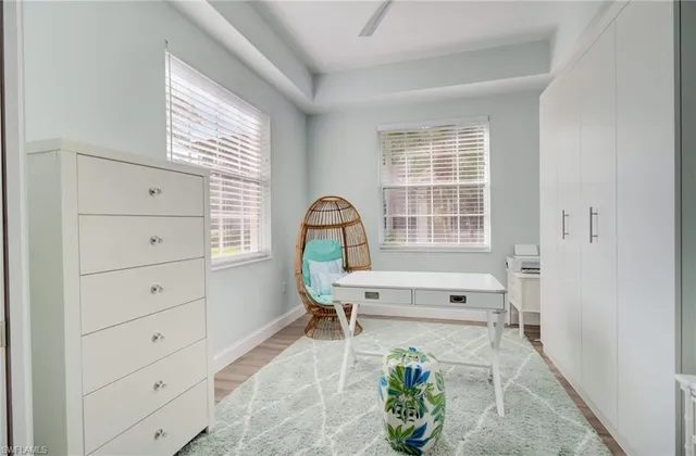 a bathroom with a granite countertop sink a toilet and a shower
