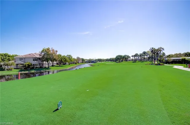 a view of dining room filled with furniture a chandelier and kitchen view