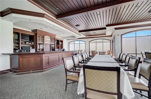 a view of a tennis ground with large trees