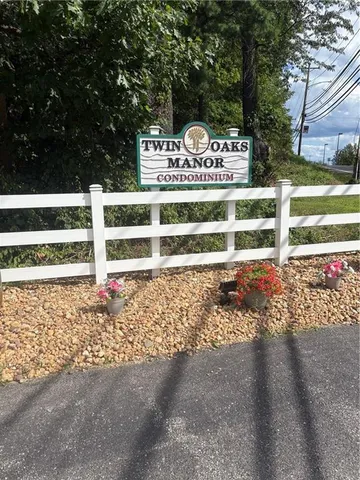 a view of a street with wooden fence