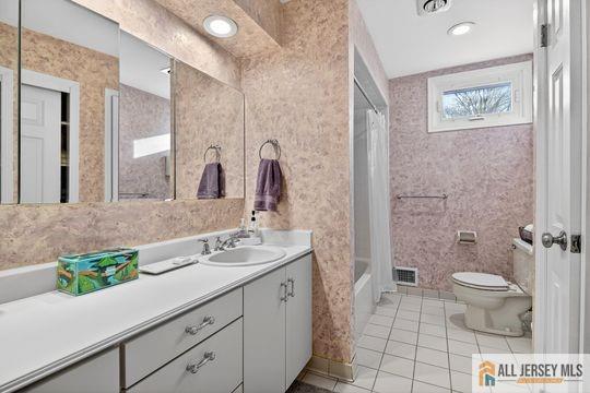 29 Darby Road East Brunswick, NJ 08816 - Photo 32 of 34 a bathroom with a granite countertop toilet a sink and a mirror