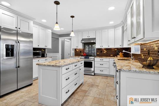 29 Darby Road East Brunswick, NJ 08816 - Photo 10 of 34 a kitchen with stainless steel appliances kitchen island granite countertop a stove a sink and a refrigerator