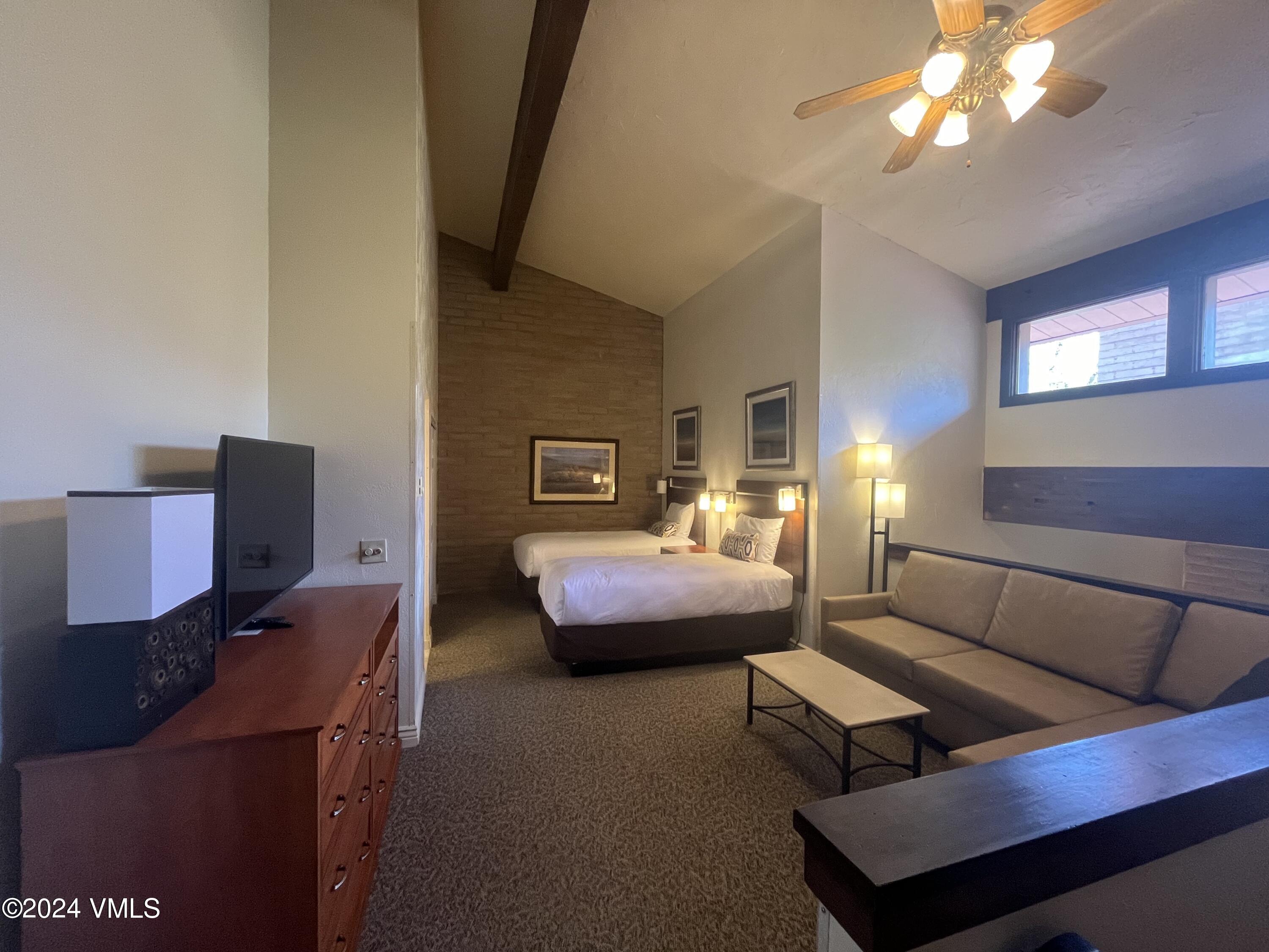 1020 Vail View Drive, Unit 340833 Vail, CO 81657 - Photo 11 of 25 a bedroom with a bed window and couch