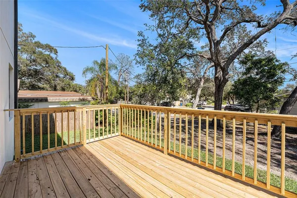 a view of balcony with wooden floor and fence