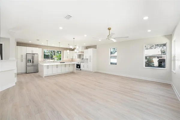 a view of a kitchen with a sink and a refrigerator