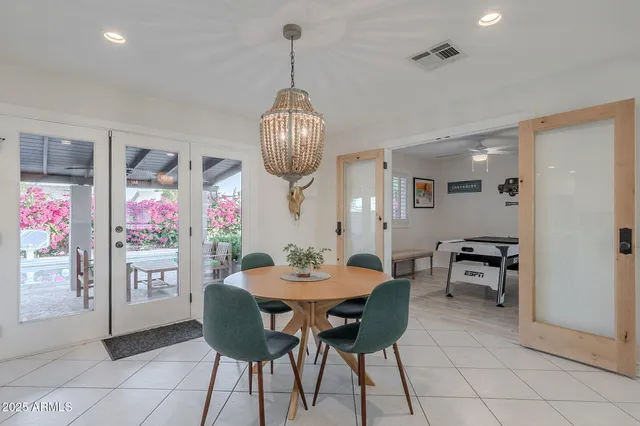 a bedroom with a bed and a lamp on dresser