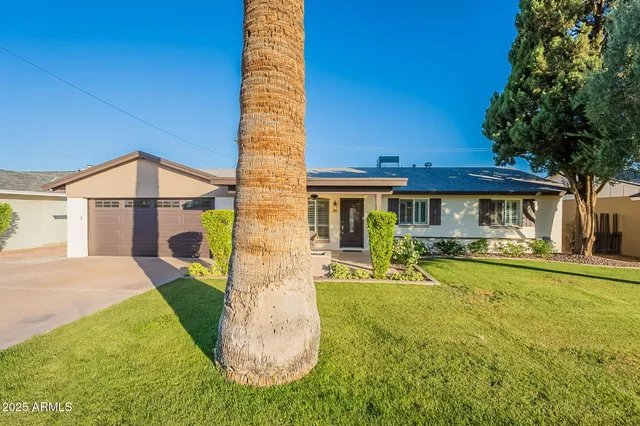 a view of a house with pool and chairs
