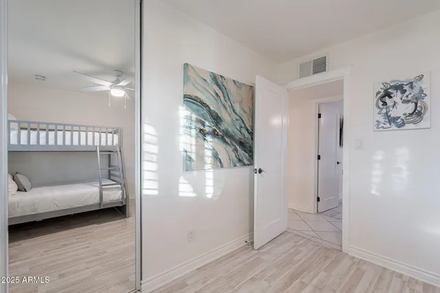 a view of a house with a big yard and large tree