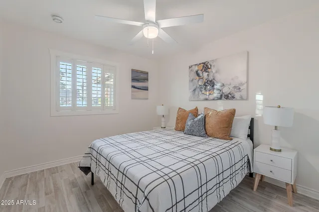 a front view of a house with a garden and trees