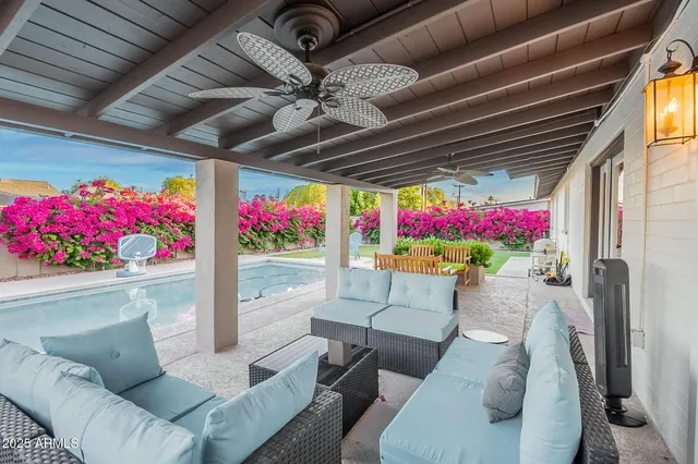 a living room with furniture a couch and wooden floor