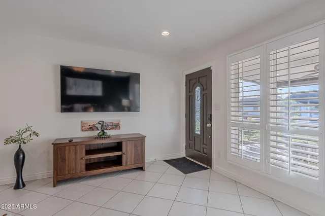 a kitchen with stainless steel appliances kitchen island granite countertop a stove a sink and a refrigerator