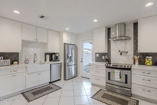 a kitchen with white cabinets and a sink