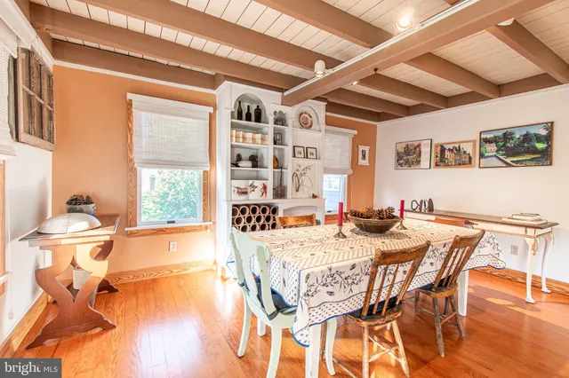 a dining room with furniture and wooden floor