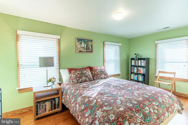 a bedroom with a large bed and a window