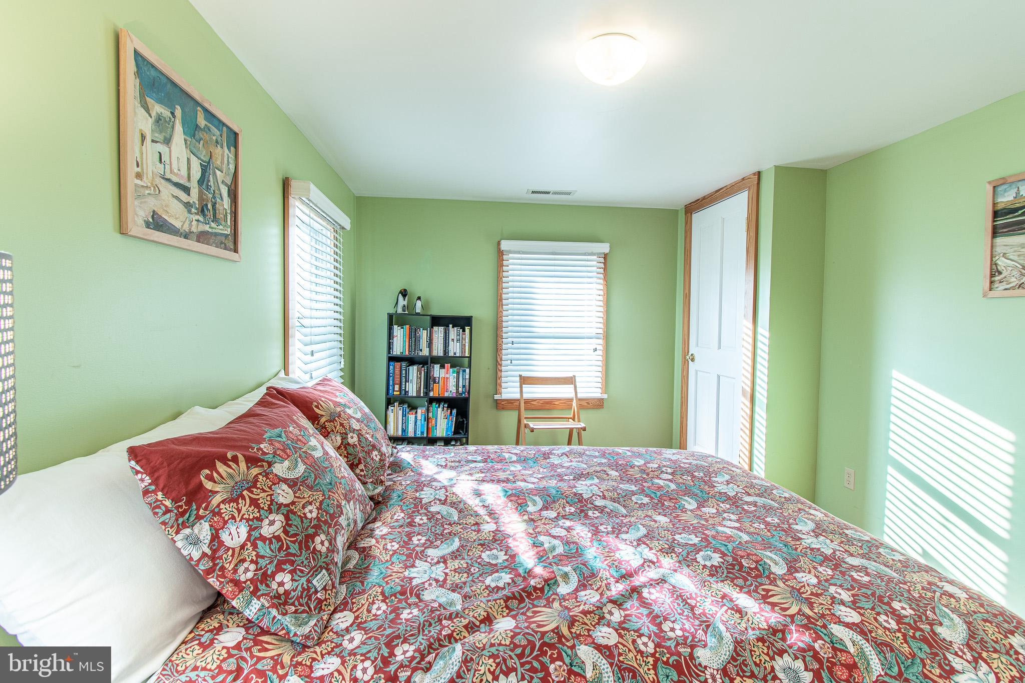 8805 Cummings Road Wittman, MD 21676 - Photo 16 of 39 a bedroom with a bed and a large window