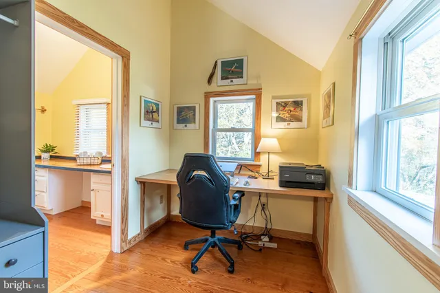 a view of a workspace with furniture and a window